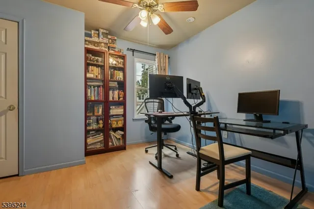 a view of a livingroom with workspace and a window
