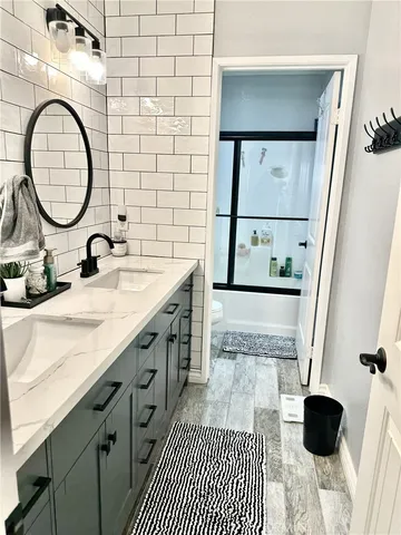 a bathroom with a sink a mirror and a shower