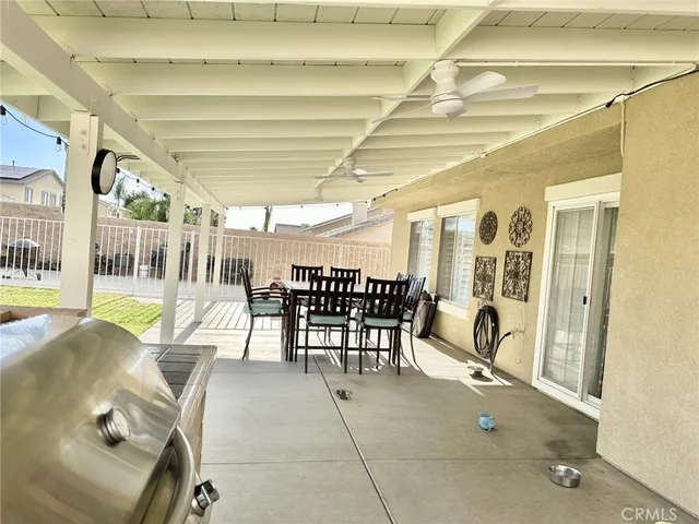 a view of a swimming pool with a patio and a yard