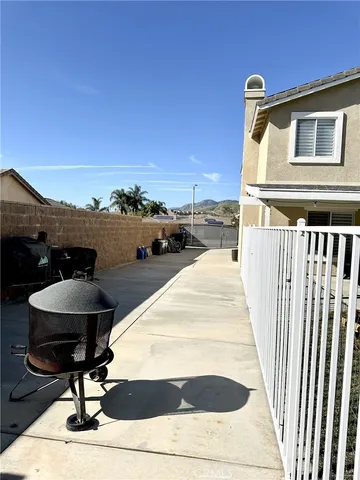a terrace with wooden floor and outdoor seating