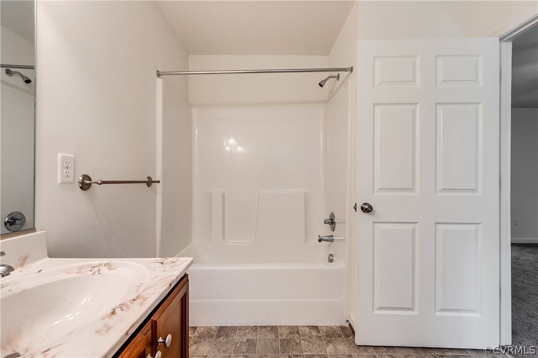 300 Winding Ridge Way Bumpass, VA 23024 - Photo 18 of 19 a bathroom with a tub a sink and a shower