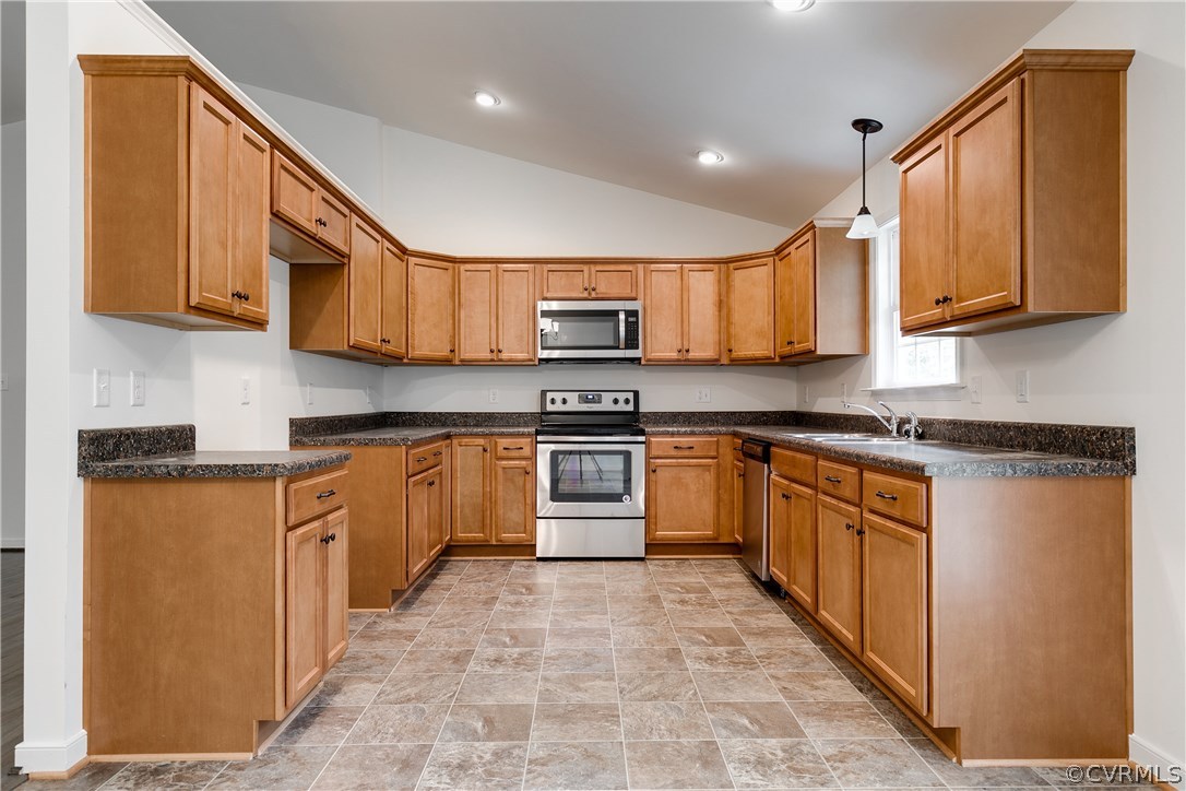 300 Winding Ridge Way Bumpass, VA 23024 - Photo 8 of 19 a kitchen with stainless steel appliances granite countertop a stove top oven a sink dishwasher and a refrigerator with wooden cabinets
