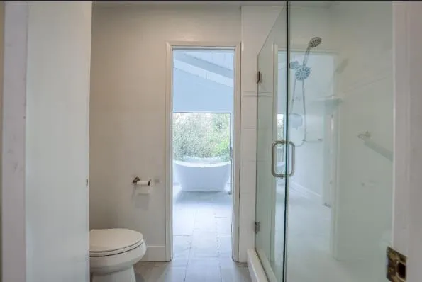 a bathroom with a granite countertop toilet a sink and shower