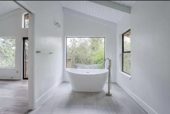 a bathroom with a bathtub and window