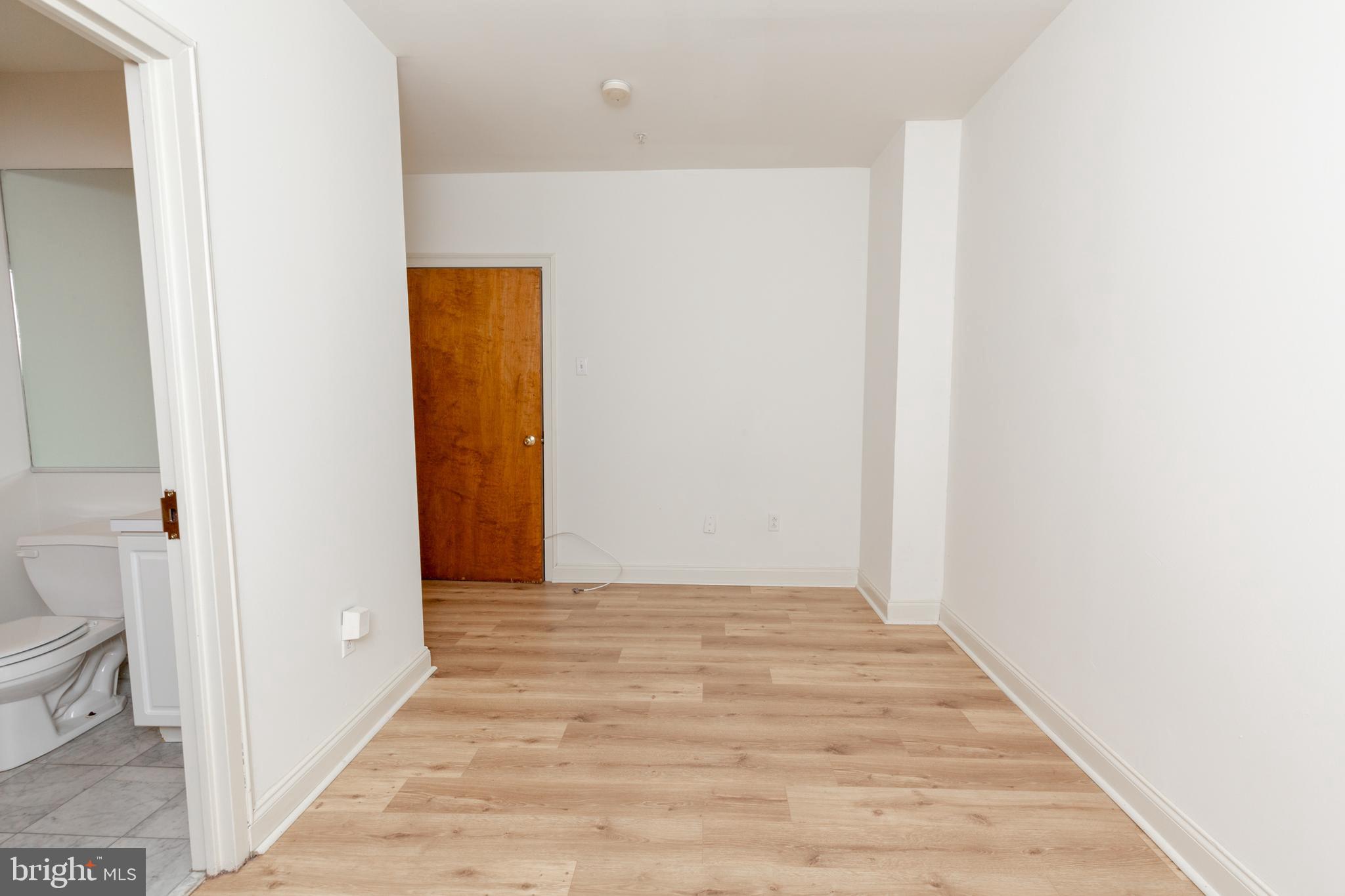 1411-5 Walnut Street, Unit 906 Philadelphia, PA 19102 - Photo 17 of 20 a view of a hallway with wooden floor