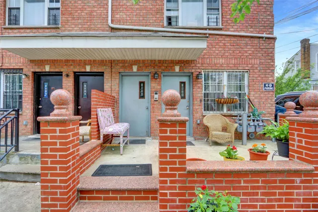 a view of a patio with couches table and chairs and potted plants
