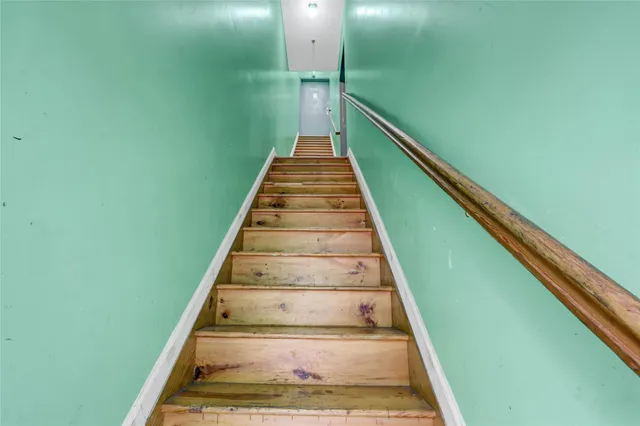a living room with furniture a rug and a lamp