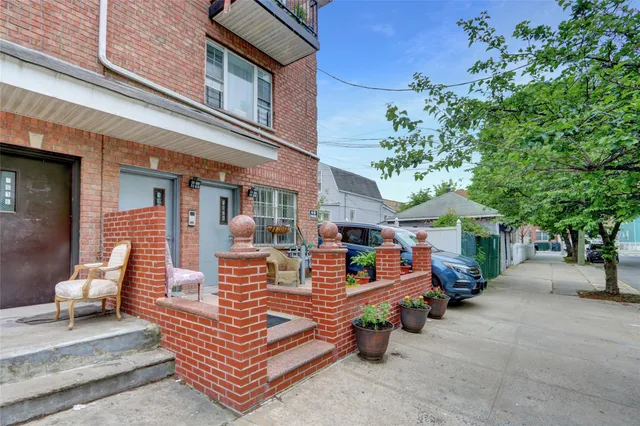 a front view of a house with outdoor seating