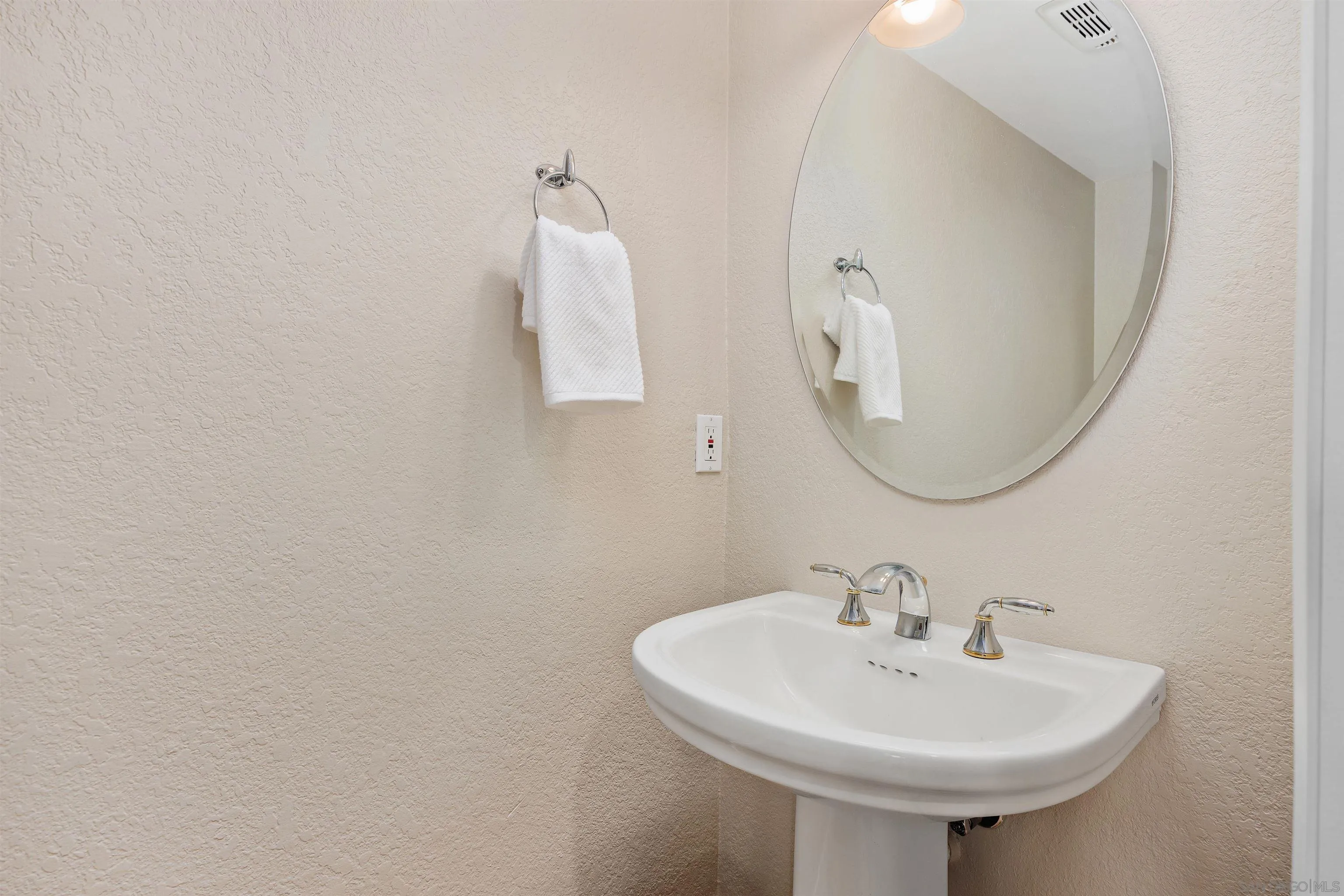 1533 Pacific Ranch Drive Encinitas, CA 92024 - Photo 21 of 52 a bathroom with a sink a mirror and a toilet