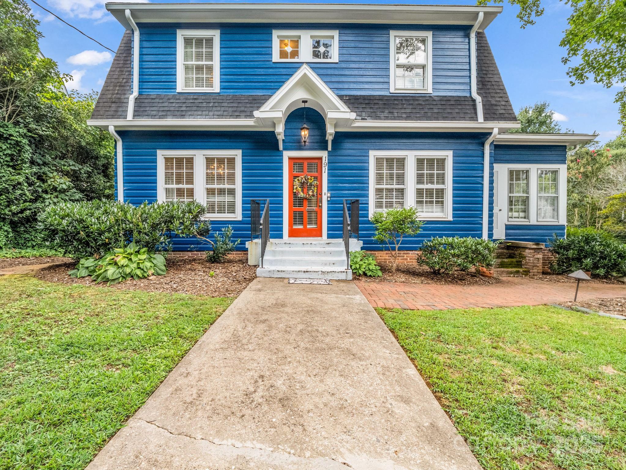 a front view of a house with garden