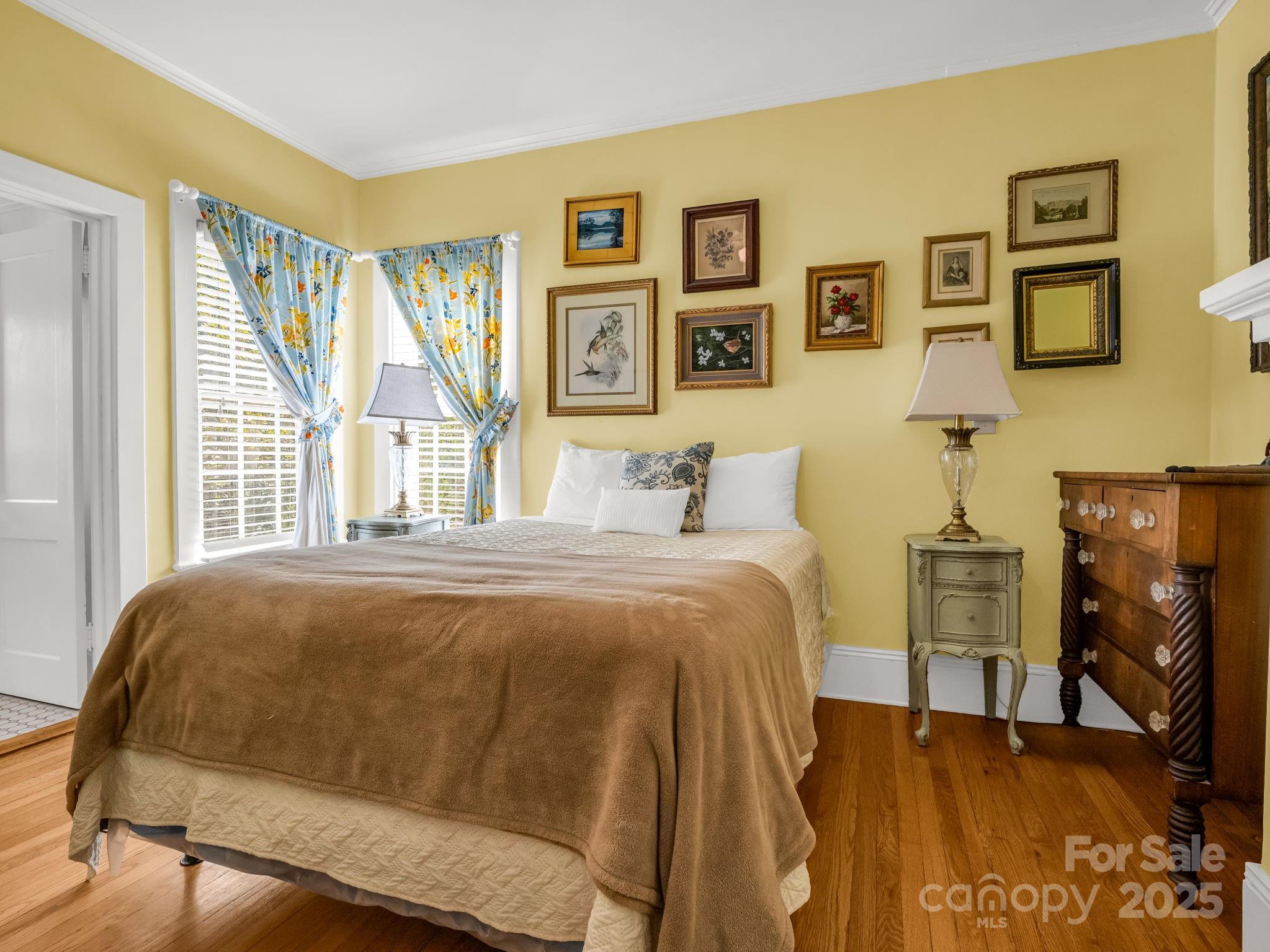 191 West 6th Street Rutherfordton, NC 28139 - Photo 16 of 38 a bedroom with a bed and wooden floor