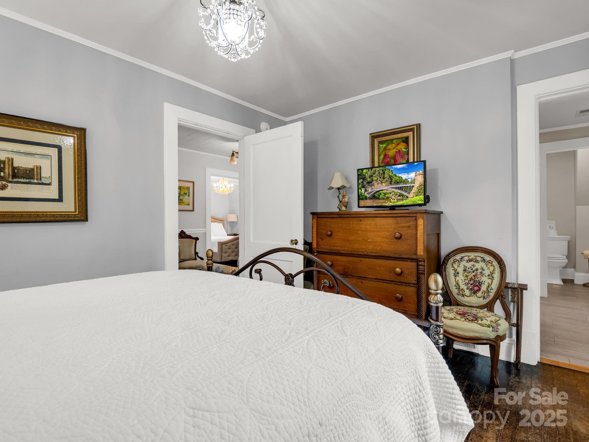 191 West 6th Street Rutherfordton, NC 28139 - Photo 23 of 38 a bedroom with bed and paintings on the wall