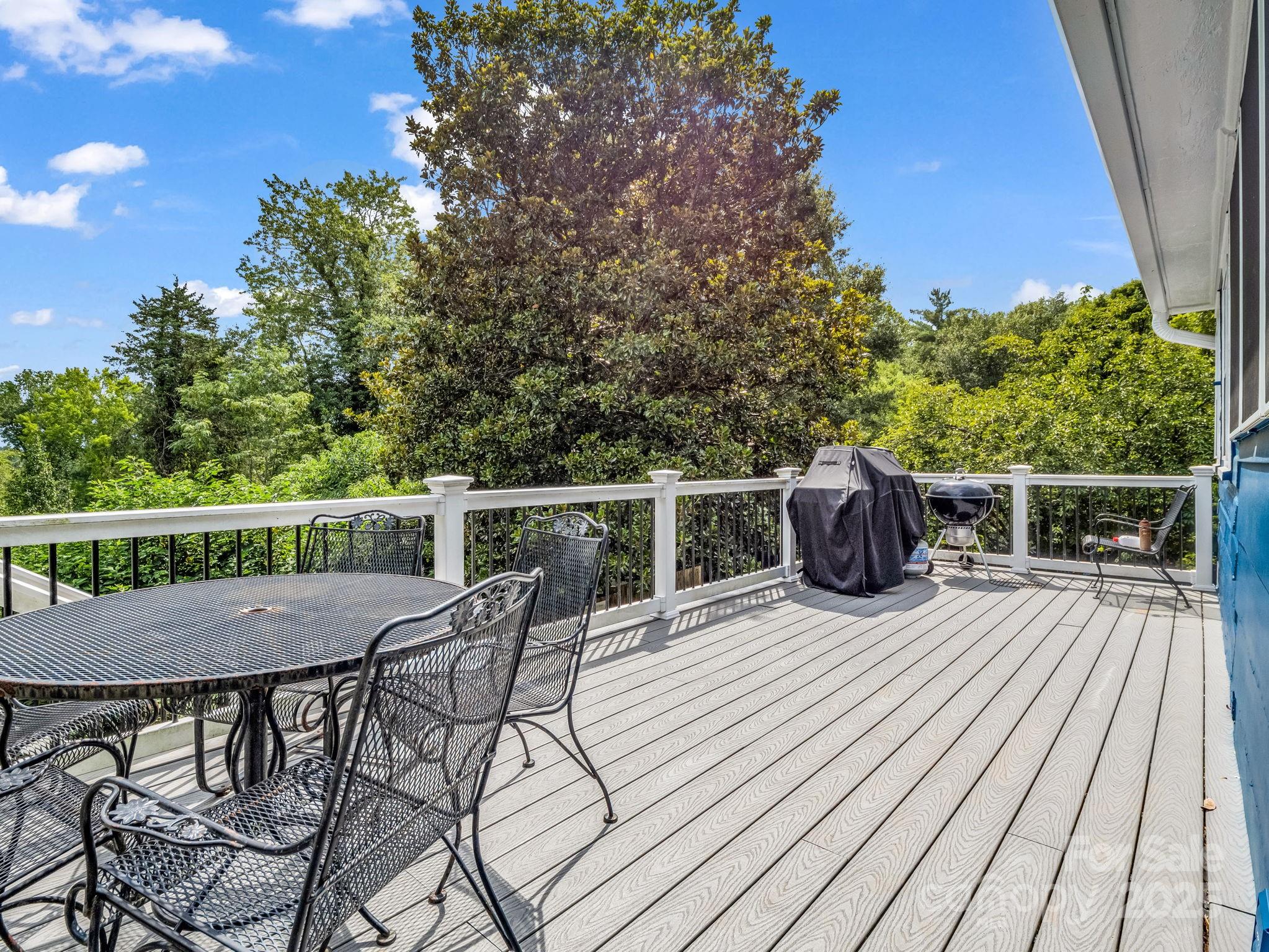 191 West 6th Street Rutherfordton, NC 28139 - Photo 32 of 38 a view of a roof deck with table and chairs and wooden floor