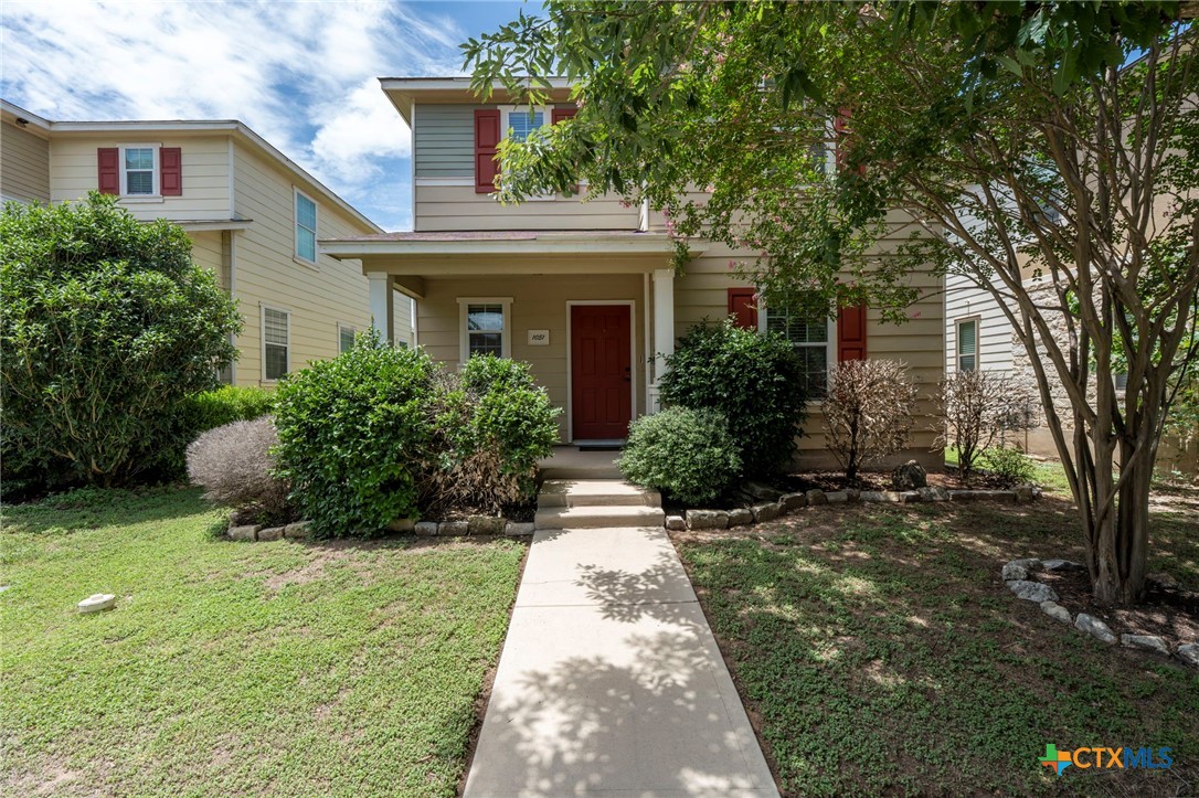a front view of a house with garden