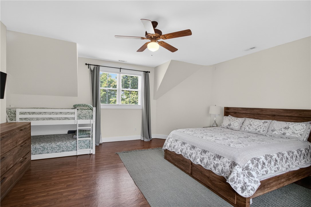 1504 Double Springs Road Townville, SC 29689 - Photo 33 of 41 This cozy bedroom features durable hardwood flooring and a functional ceiling fan for comfort.