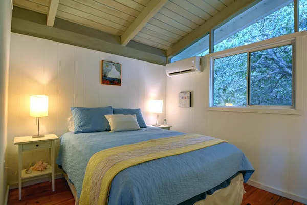 a bedroom with a bed and a window
