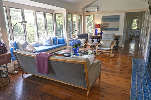 a living room with furniture and large windows