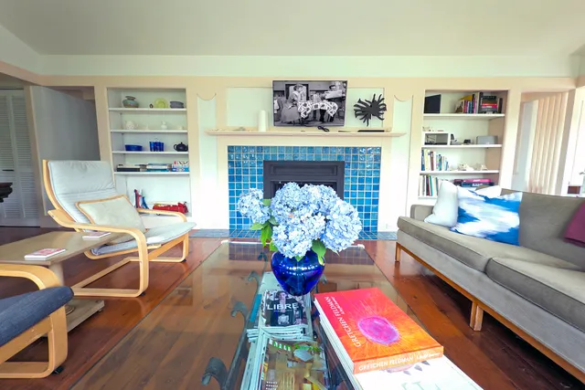 a living room with furniture fireplace and a window