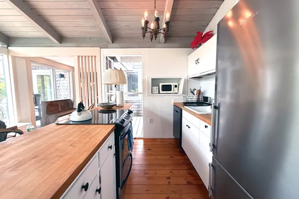 a kitchen with stainless steel appliances kitchen island granite countertop a sink and cabinets