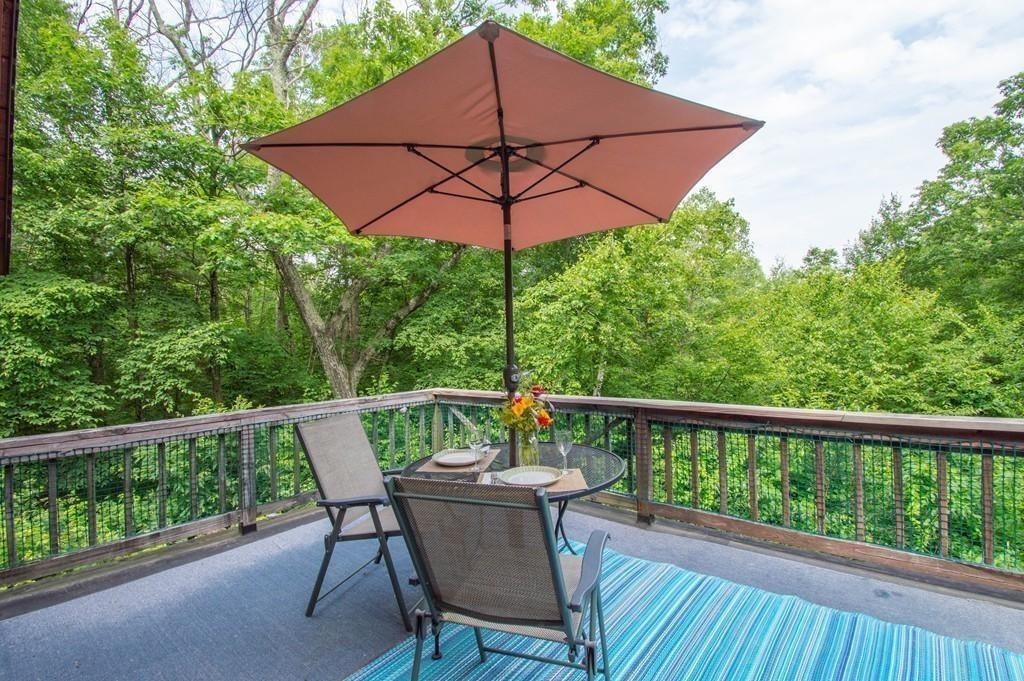 40 Paradise Lake Road Monson, MA 01057 - Photo 5 of 15 a view of balcony with furniture and an umbrella