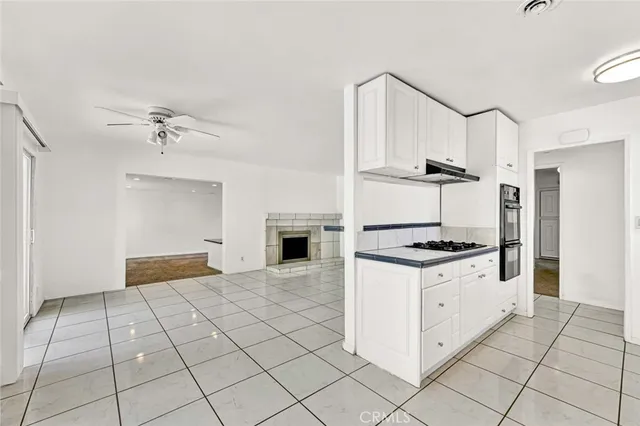 a kitchen with granite countertop a stove a sink and a refrigerator