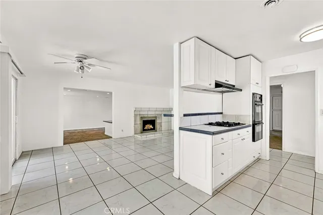 a kitchen with granite countertop a stove a sink and a refrigerator