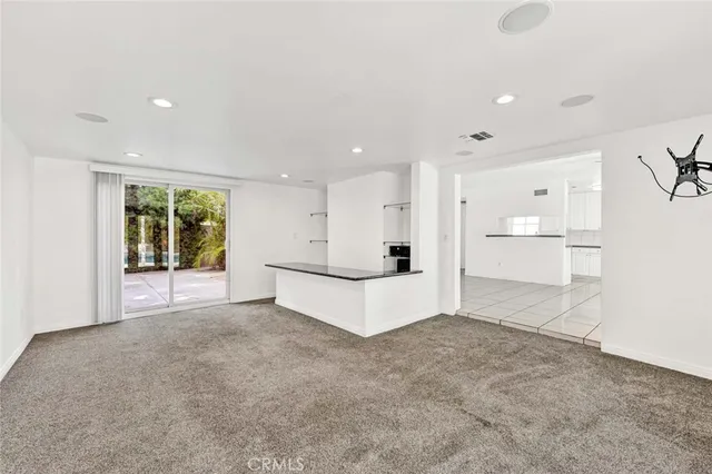 a view of a kitchen with large windows
