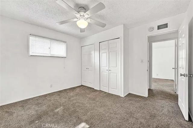 an empty room with a ceiling fan