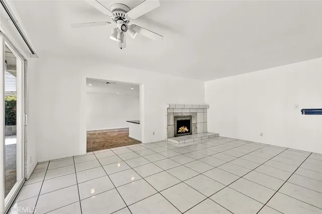 an empty room with windows and fireplace