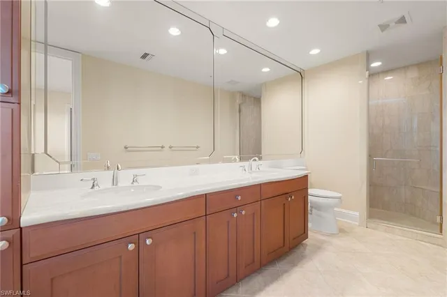 a bathroom with a double vanity sink toilet and a mirror