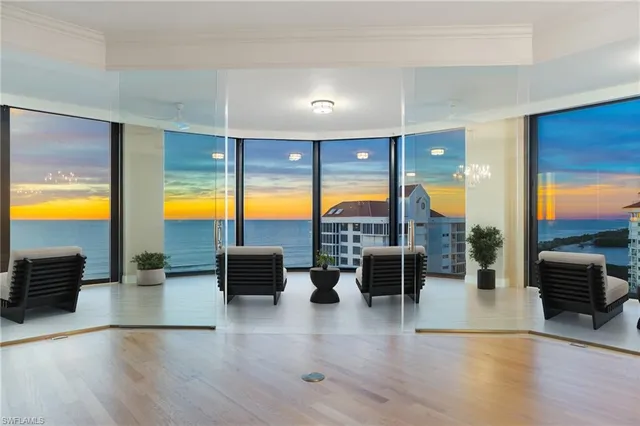 an outdoor living space with furniture and floor to ceiling window