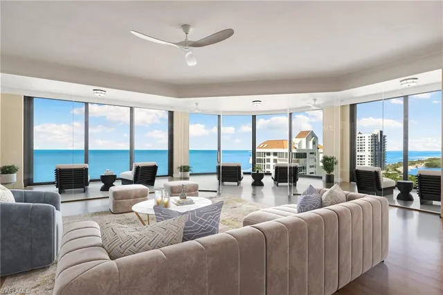 a living room with furniture and large windows