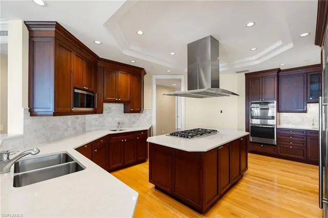 a kitchen with stainless steel appliances granite countertop a sink stove and refrigerator