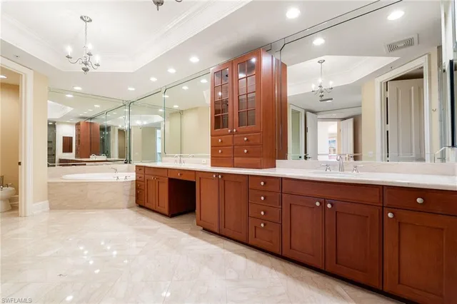 a large bathroom with a large tub and sink