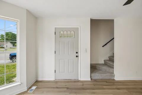 wooden floor in an empty room with a window