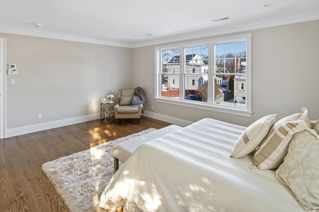 114 Bow Street Lexington, MA 02420 - Photo 19 of 34 a bedroom with a bed and a large window