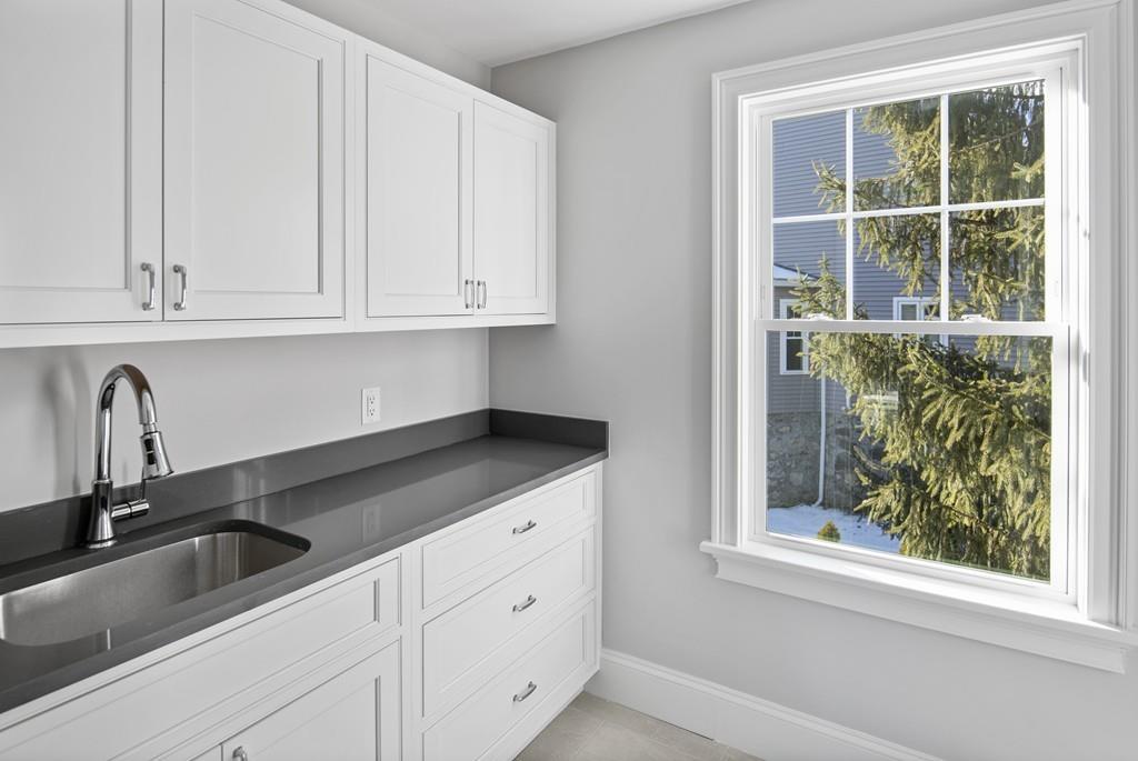 114 Bow Street Lexington, MA 02420 - Photo 23 of 34 a kitchen with granite countertop white cabinets and window