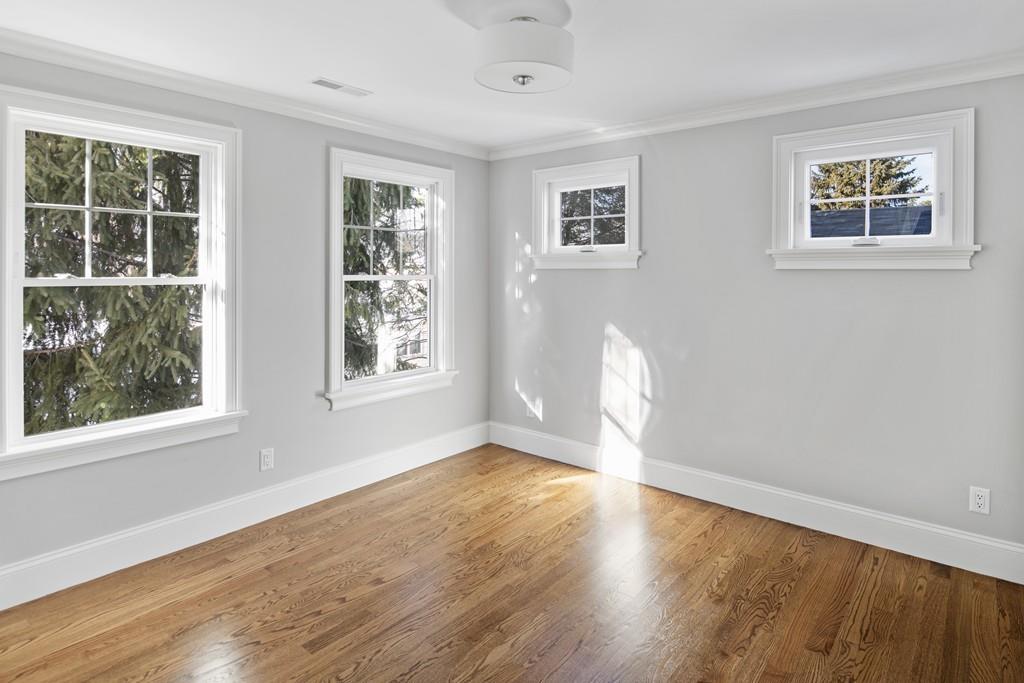 114 Bow Street Lexington, MA 02420 - Photo 26 of 34 a view of empty room with wooden floor and fan