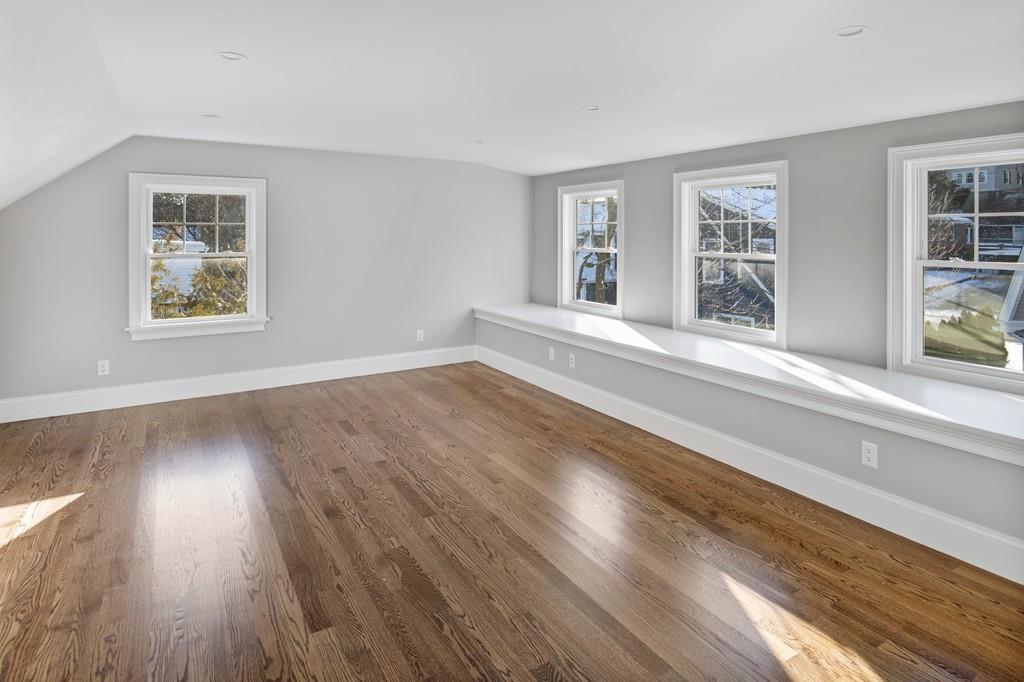 114 Bow Street Lexington, MA 02420 - Photo 28 of 34 a view of an empty room with wooden floor and a window
