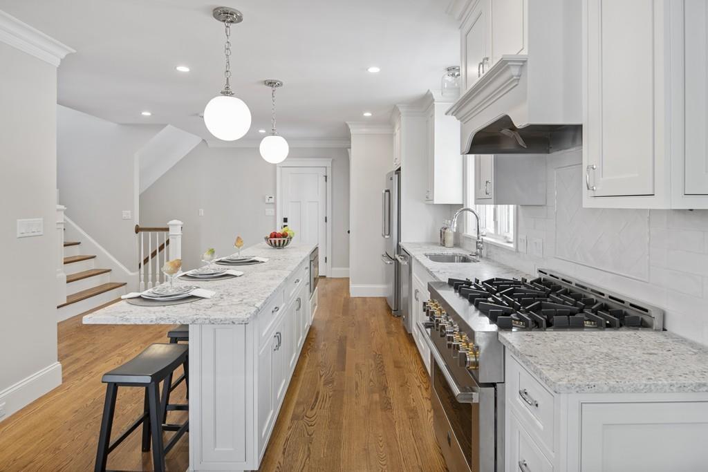 114 Bow Street Lexington, MA 02420 - Photo 5 of 34 a kitchen with stainless steel appliances granite countertop a sink stove and cabinets
