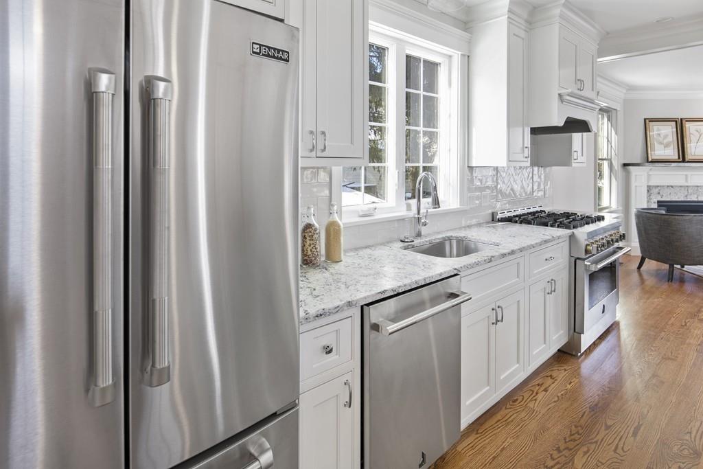 114 Bow Street Lexington, MA 02420 - Photo 7 of 34 a kitchen with granite countertop a sink stove and refrigerator
