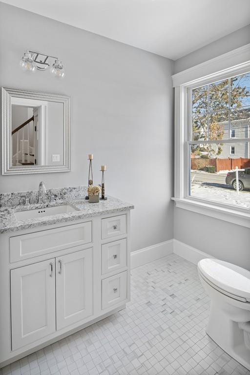 114 Bow Street Lexington, MA 02420 - Photo 9 of 34 a bathroom with a granite countertop toilet sink and mirror