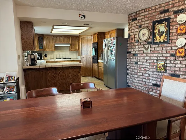 a kitchen with a sink a stove and wooden floor