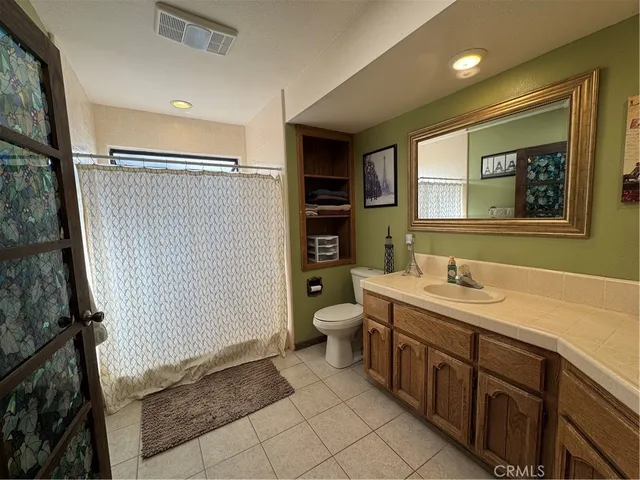 a spacious bathroom with a double vanity sink a mirror and a shower