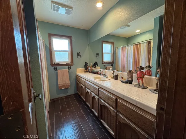 a bathroom with a double vanity sink and a mirror