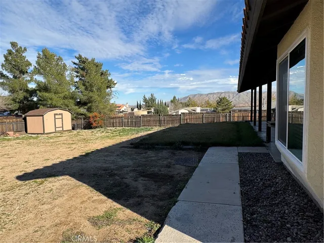 a view of a pathway with a wrought fence