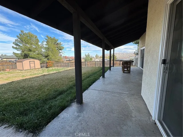 a view of a porch with chairs and backyard