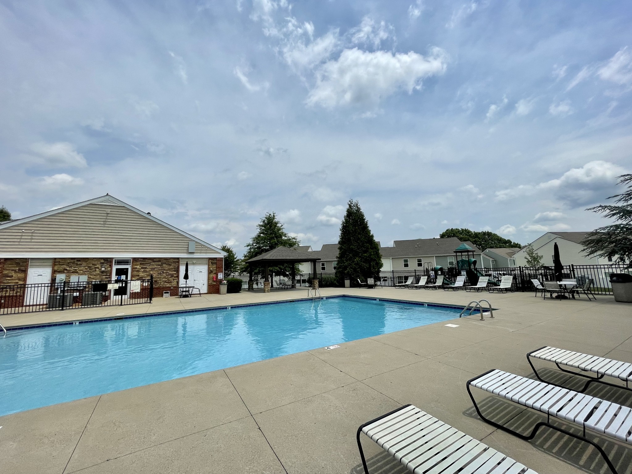 6052 Hillside Lane Spring Hill, TN 37174 - Photo 23 of 23 a view of a swimming pool with lawn chairs and potted plants