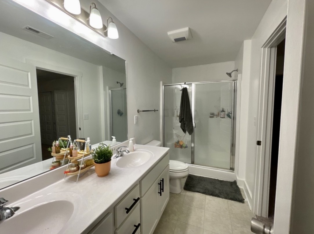 6052 Hillside Lane Spring Hill, TN 37174 - Photo 10 of 23 a bathroom with a double vanity sink mirror double and shower