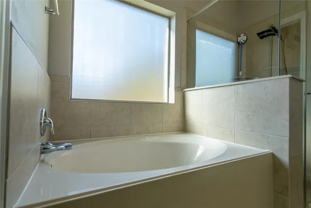 a bathroom with a shower and a sink